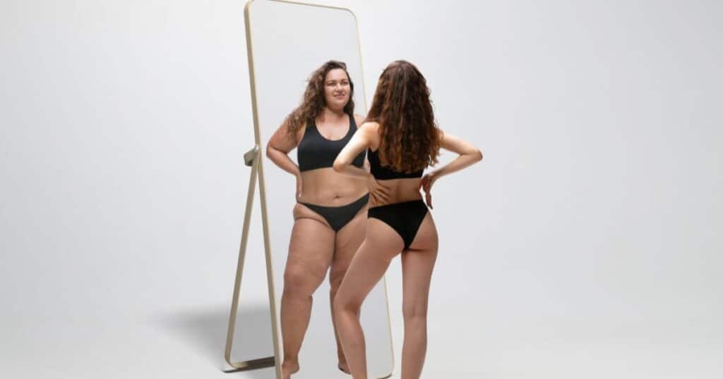 Woman looking at her reflection promoting Ozempic weight loss injections offered at Health First Medical Weight Loss in Hesperia, Redlands, and Rancho Cucamonga, CA