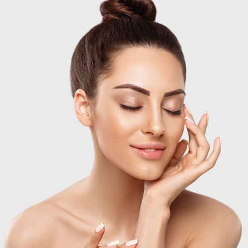 Attractive woman touches her face promotes PDO Thread Lift available in Rancho Cucamonga, Hesperia, and Redlands, California